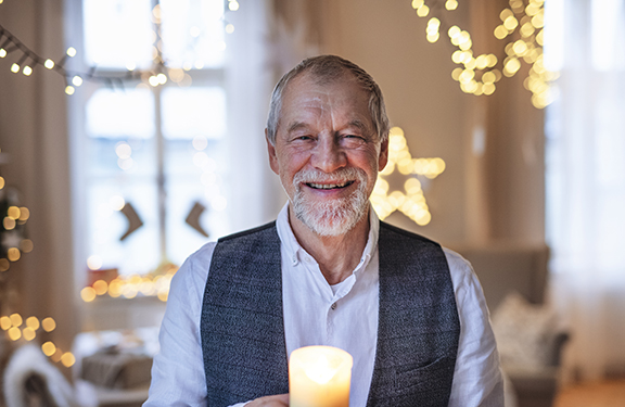 Older man holding candle